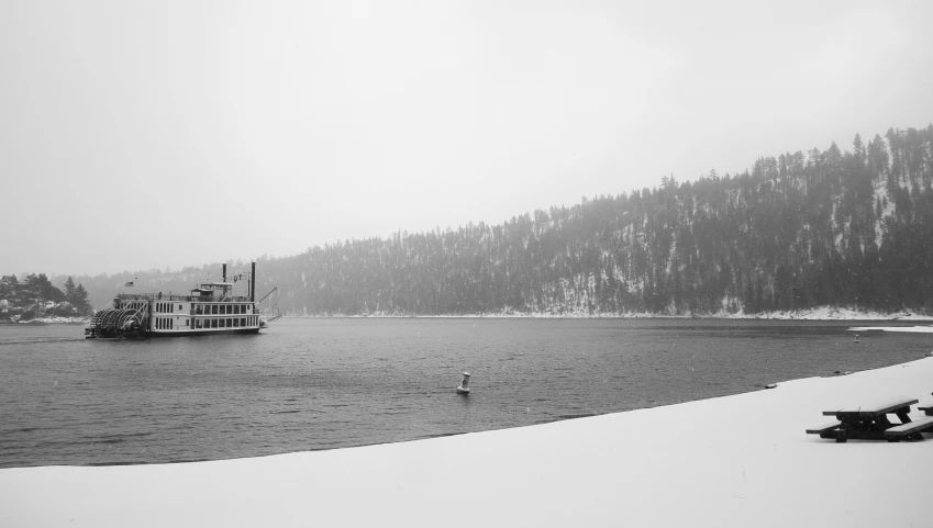 a small boat is out on the water near trees