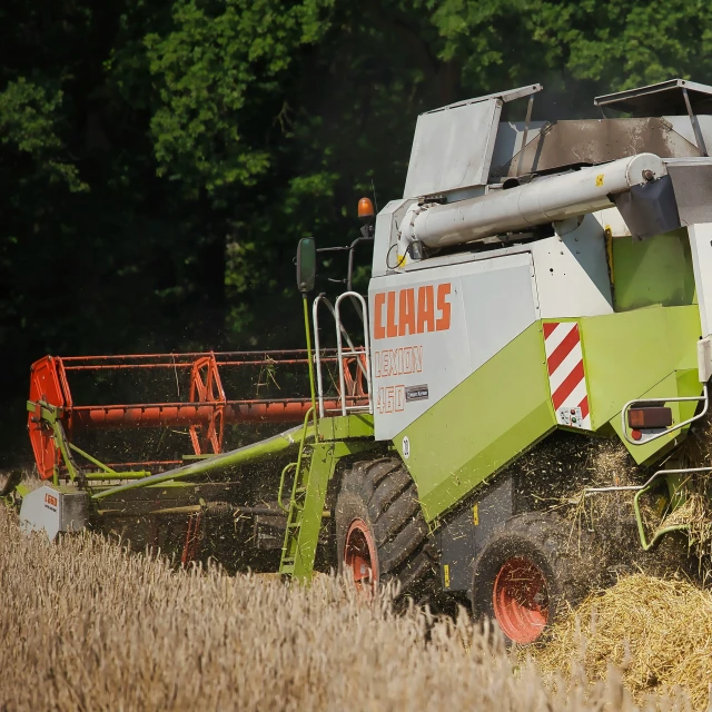 a large farm vehicle is working in the field