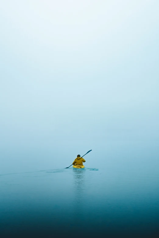 a person paddling in a boat on the ocean