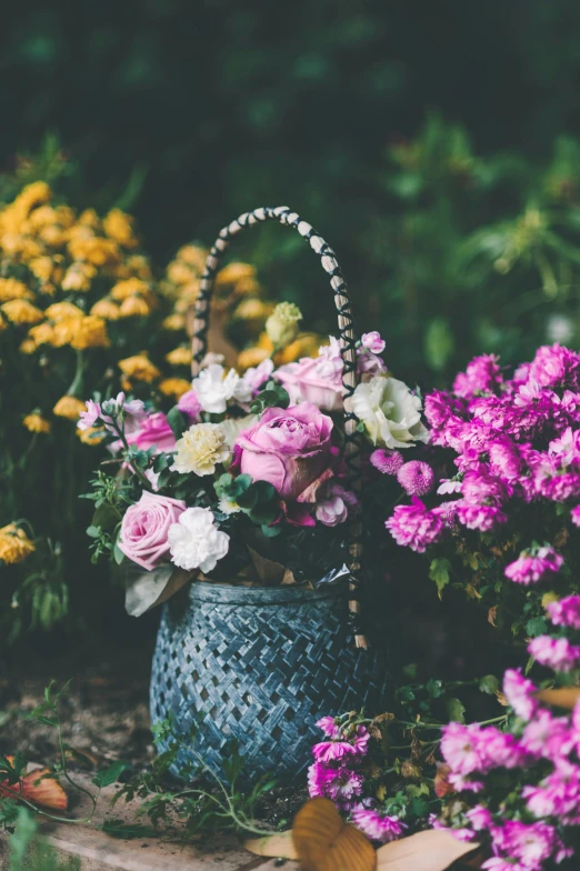 a flower bouquet is placed in the garden bucket