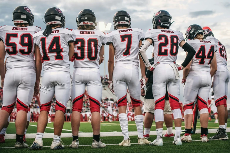 a group of football players standing on a field