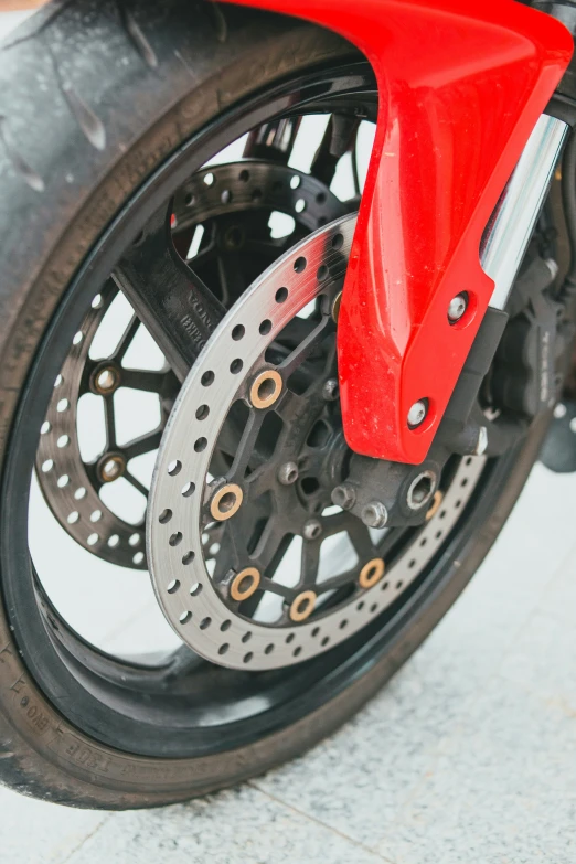 a closeup s of the kes on a red motorcycle