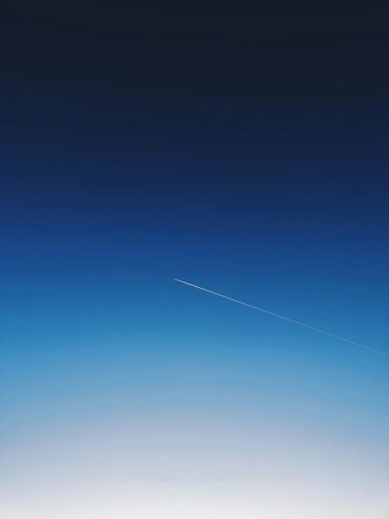 airplane flying over a snow covered field with a sky background