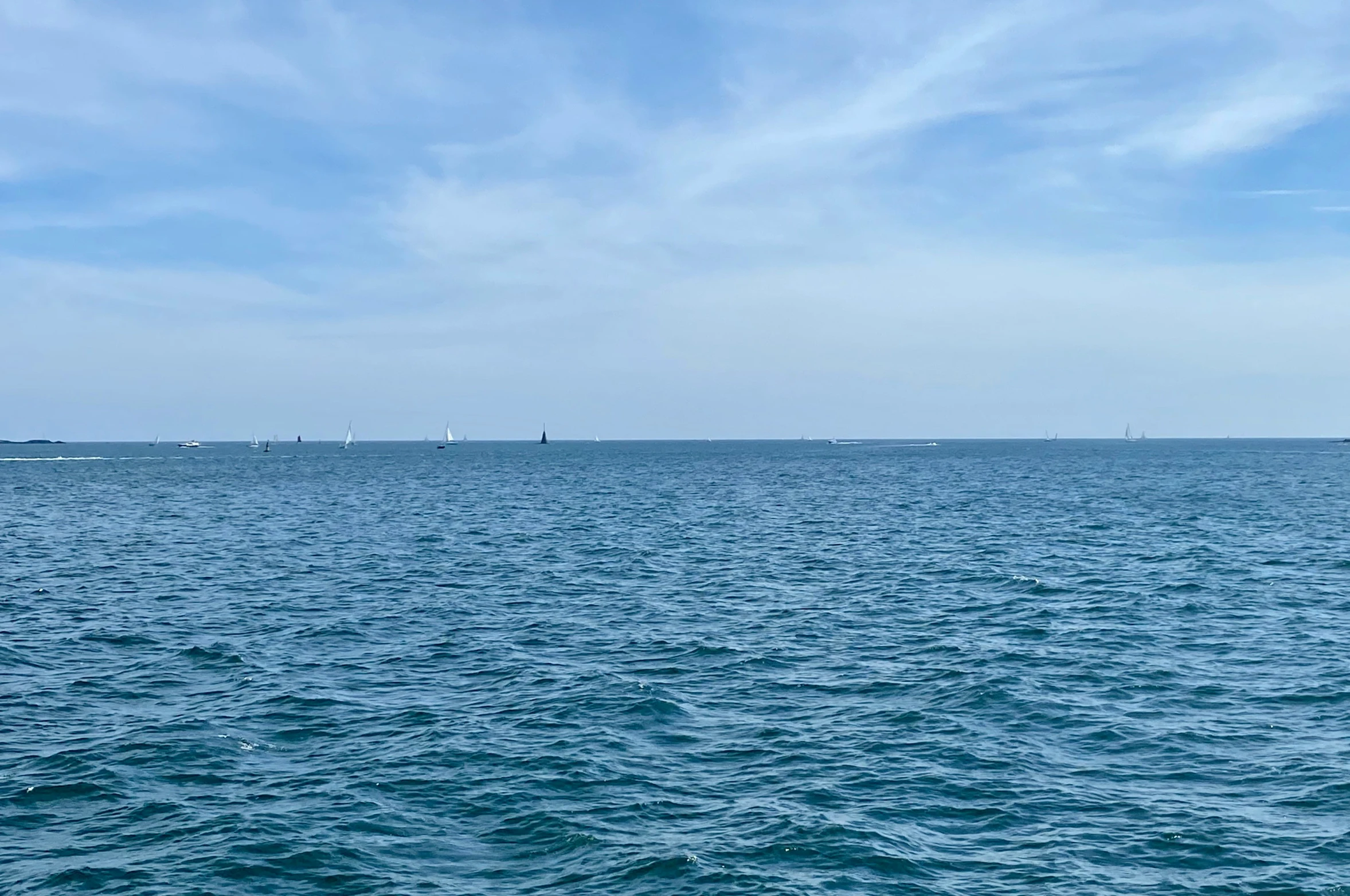 a body of water that has some boats out on the ocean