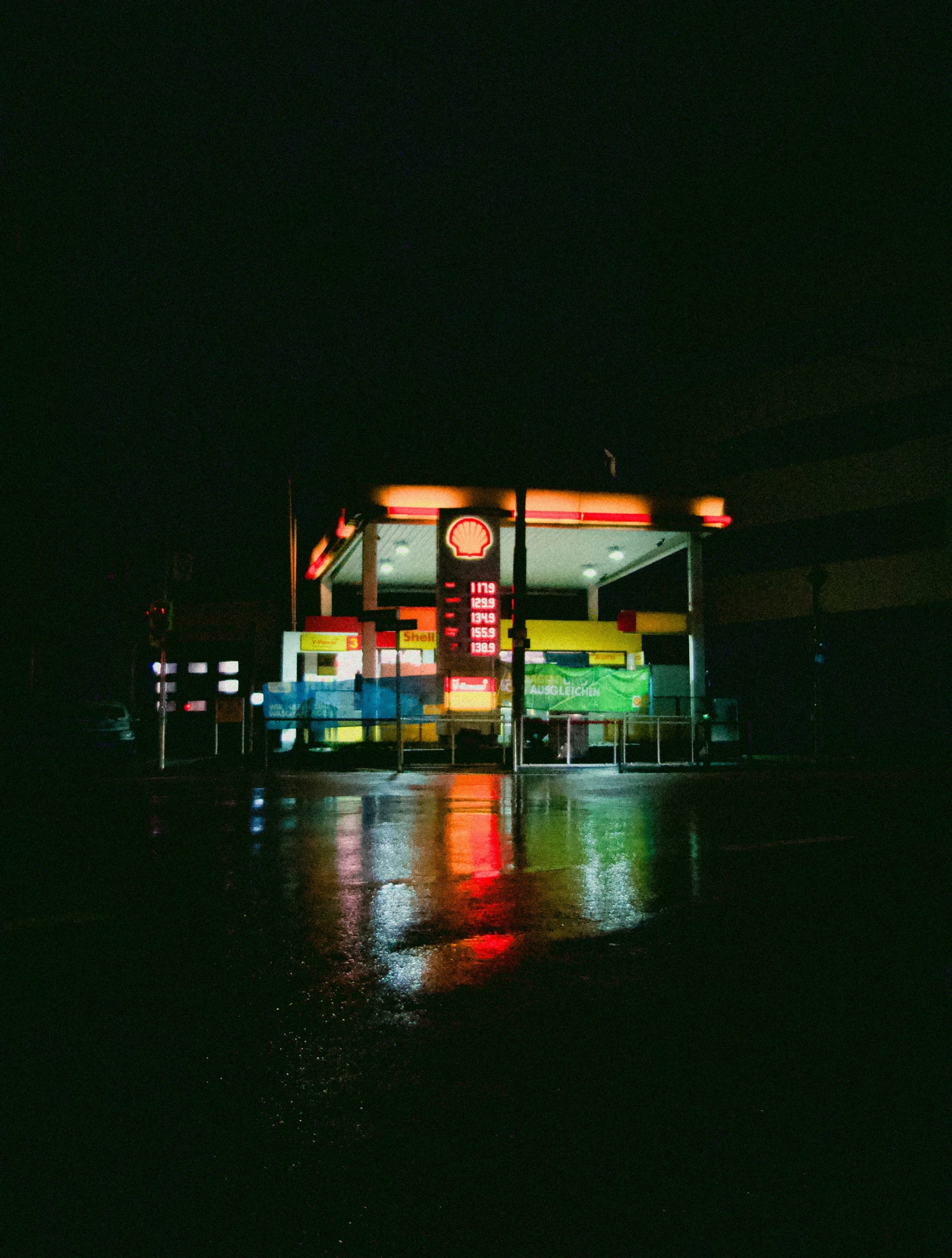 the front of a diner sitting on the side of the road at night