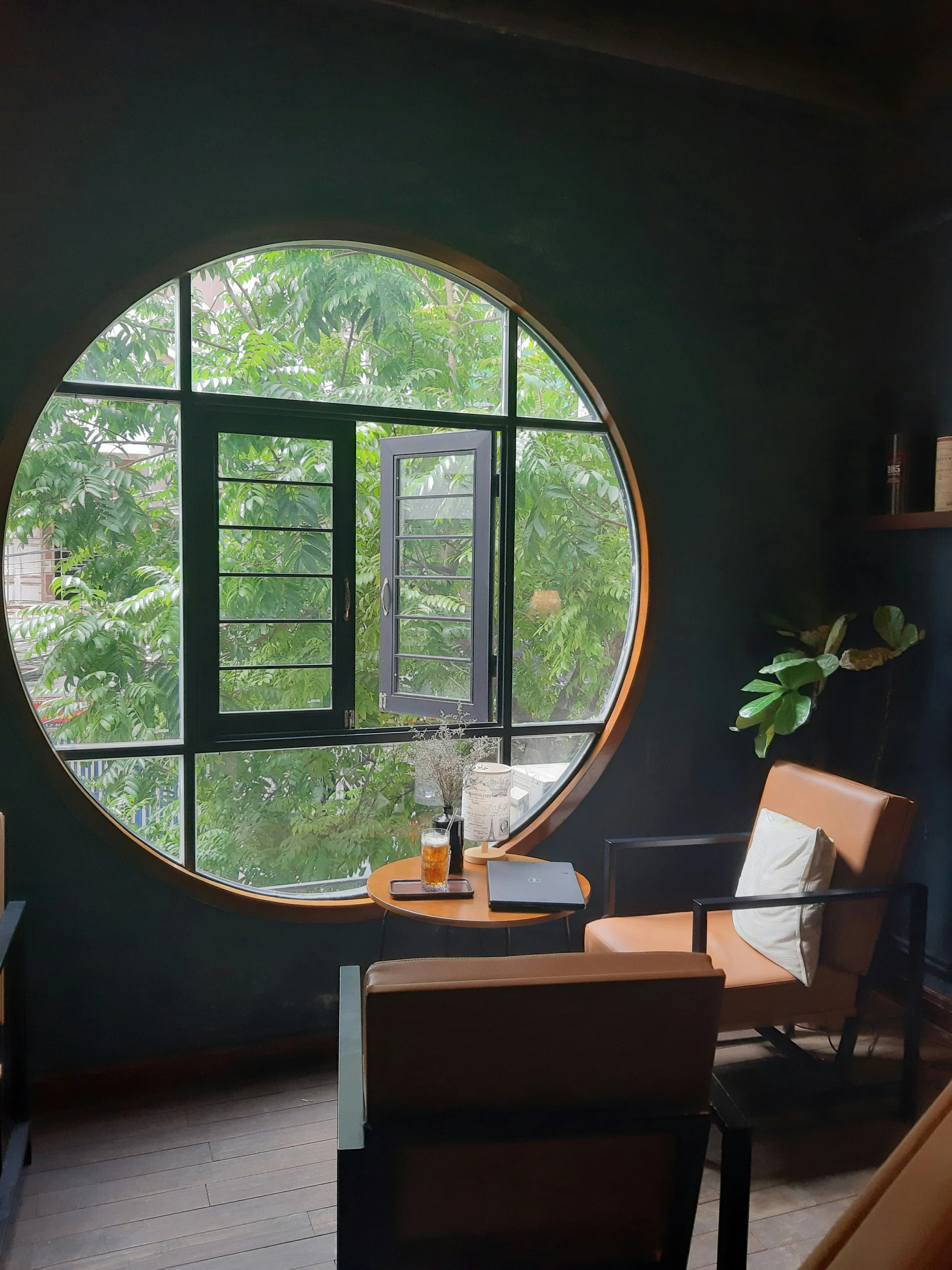 a living room with a circular window and chair