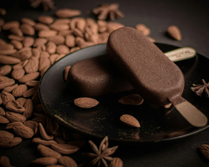 chocolate ice cream pops on top of almonds