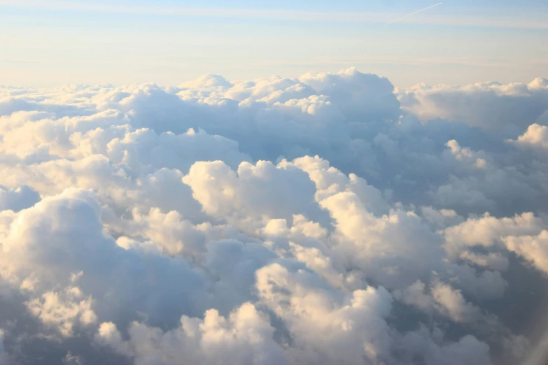 a large flock of clouds are high up in the sky