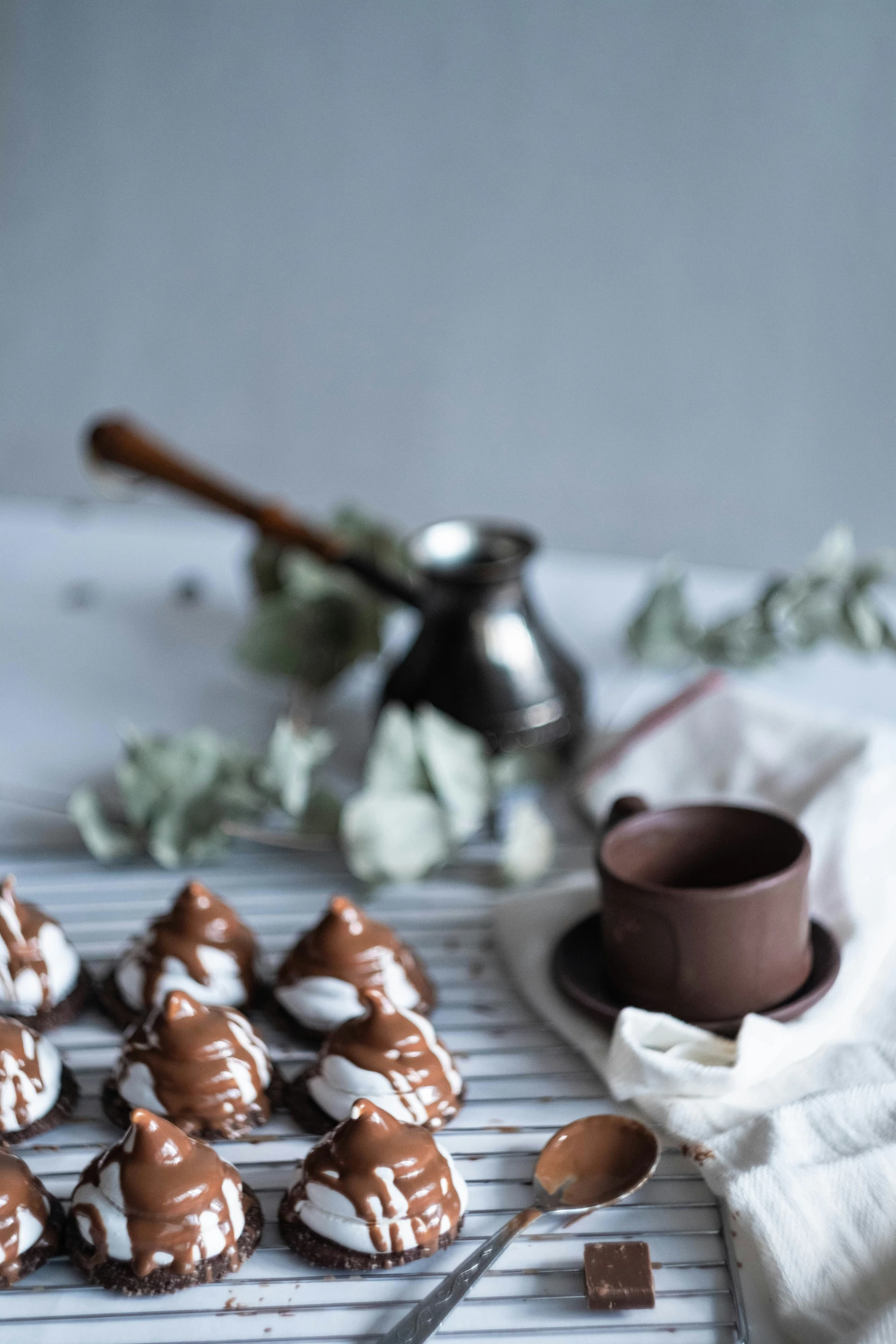 chocolate heart shaped candies on a rack with a mug and knife