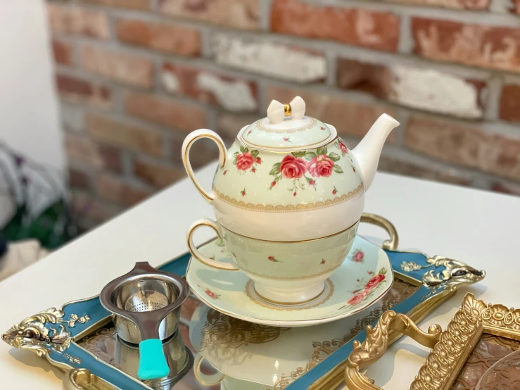 a glass and porcelain tea set with roses