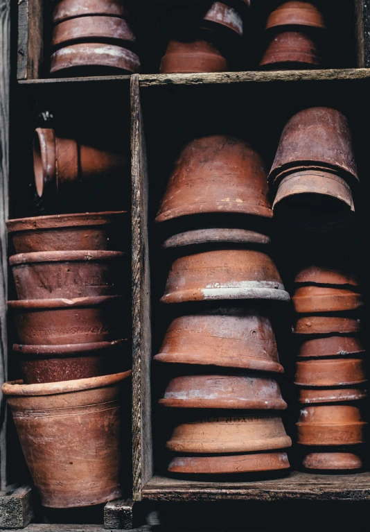 a wooden box filled with lots of brown pot