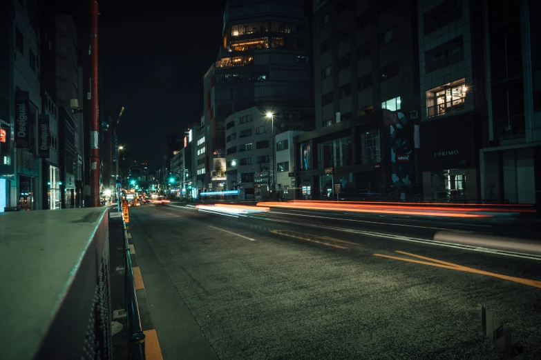 a view of a street at night with buildings in the background