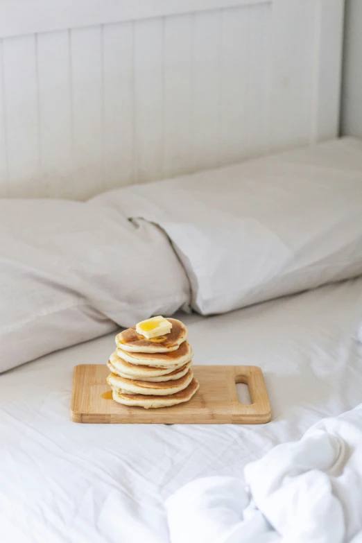 several pancakes are on a tray, next to an open laptop