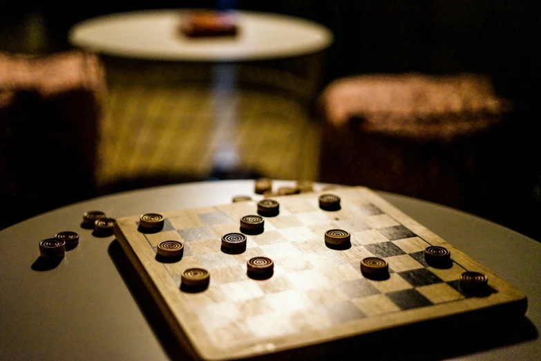 there is a wooden chess board with two pieces on it