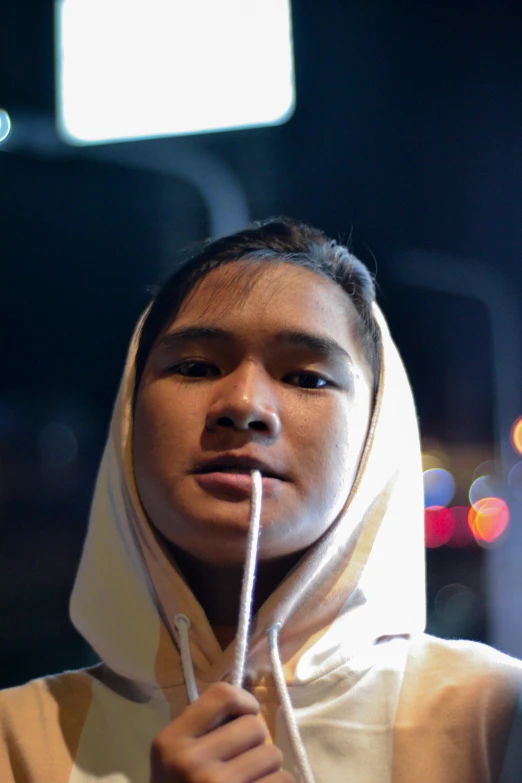 a girl holding a stick with light blurry boke in background