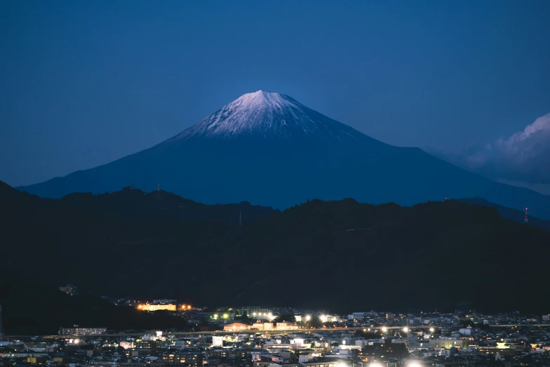 a large mountain with night lights on it