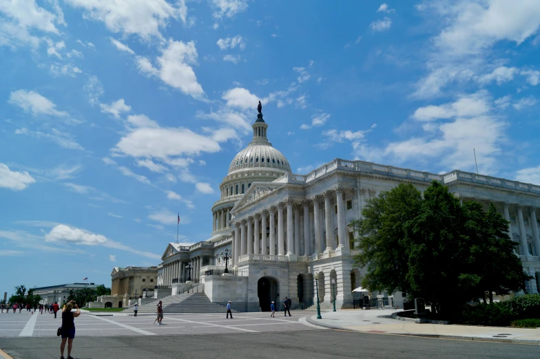 people stand in front of the capitol building