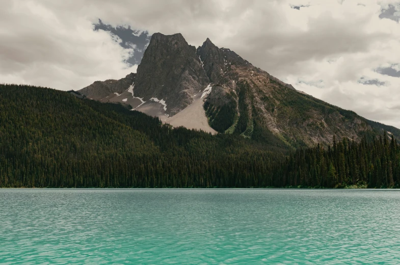 the top of a mountain stands above the water