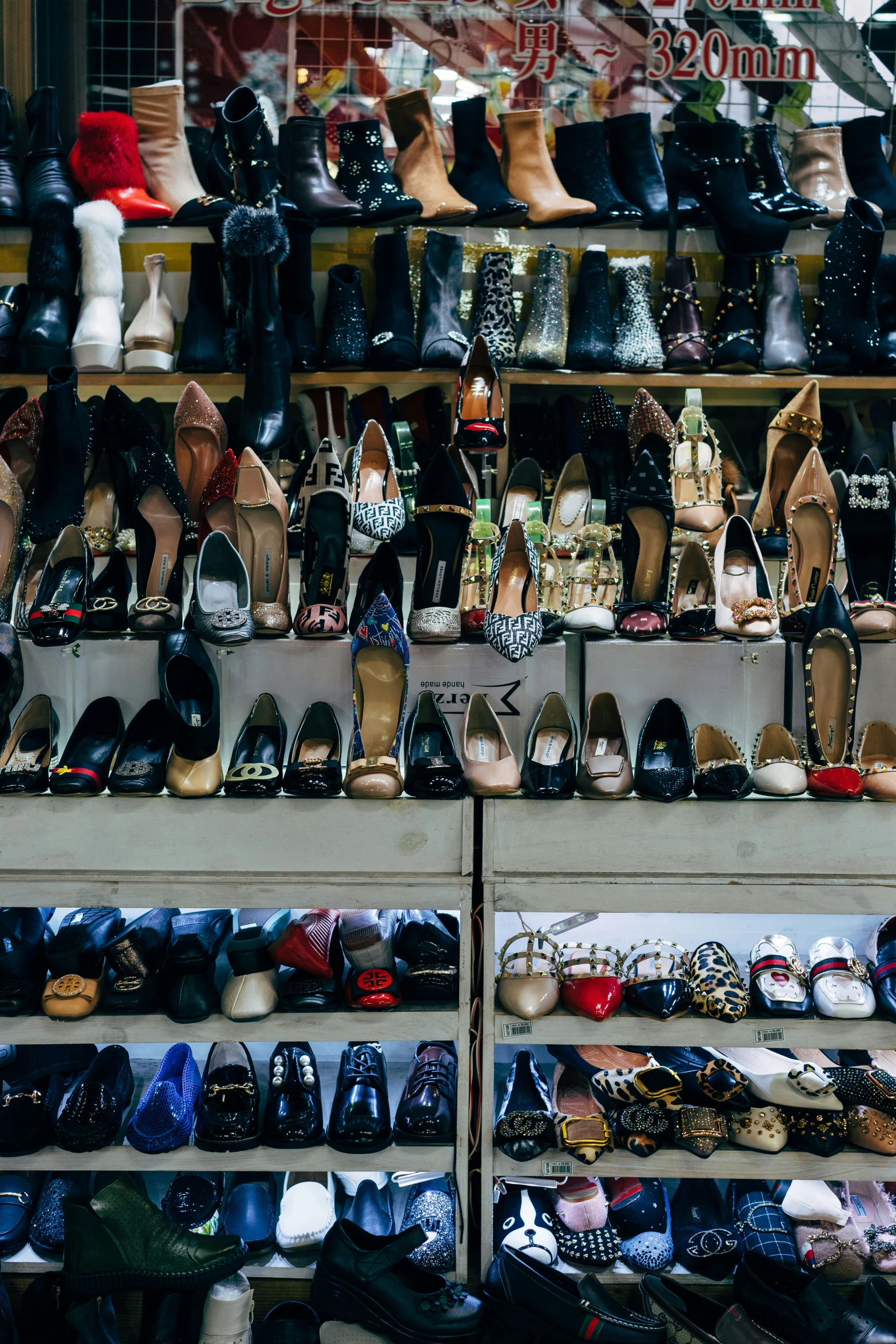 rows of shoes and footwear displayed in a shop window