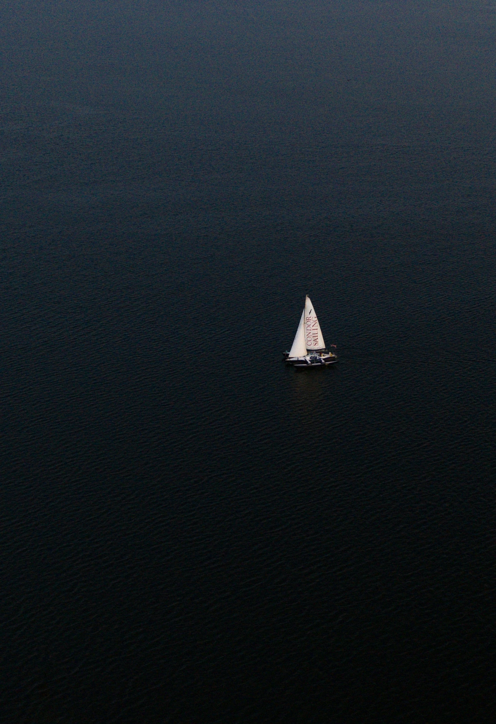 a sail boat in the middle of the water