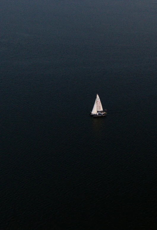 a sail boat in the middle of the water