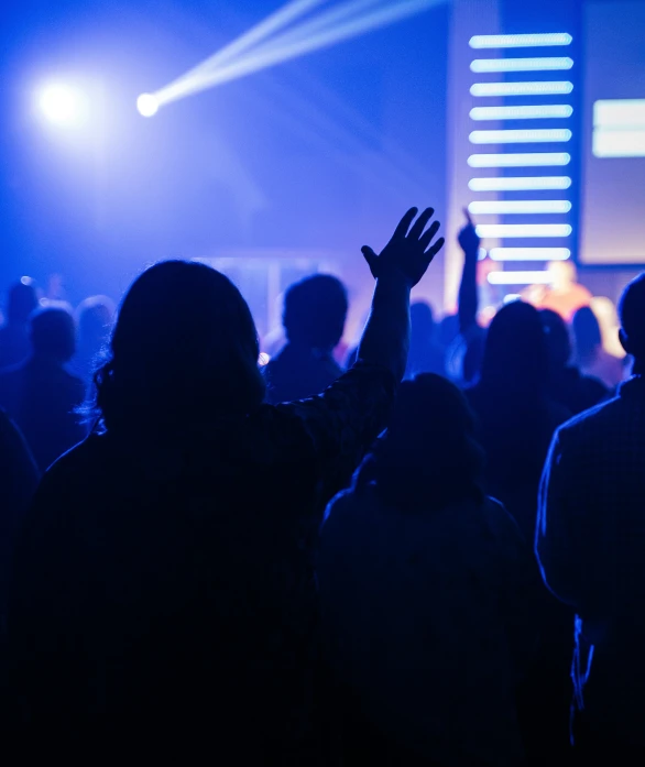 a group of people at a concert in front of a stage