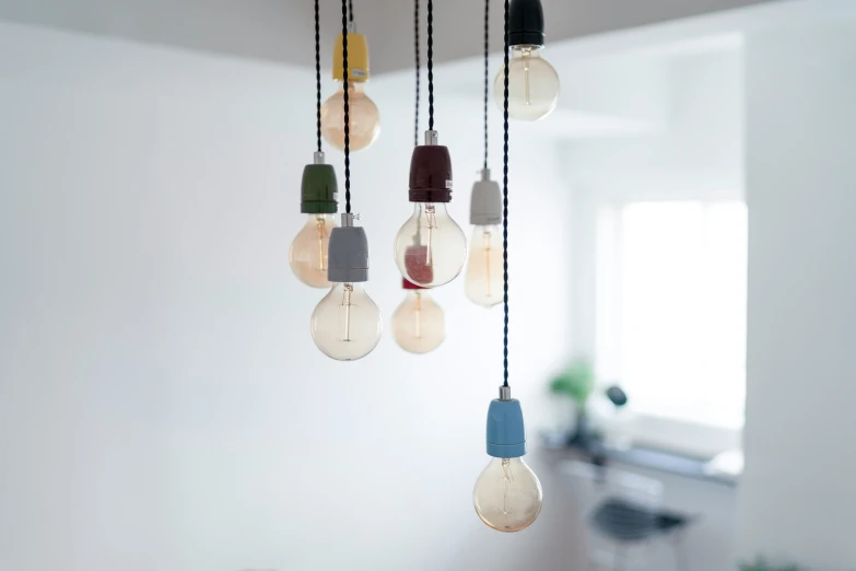 various colored light bulbs hanging from the ceiling