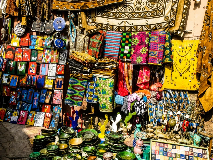 a marketplace has many colorful fabrics and souvenirs