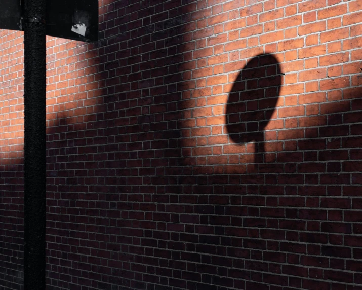 a red brick wall that is next to a street light