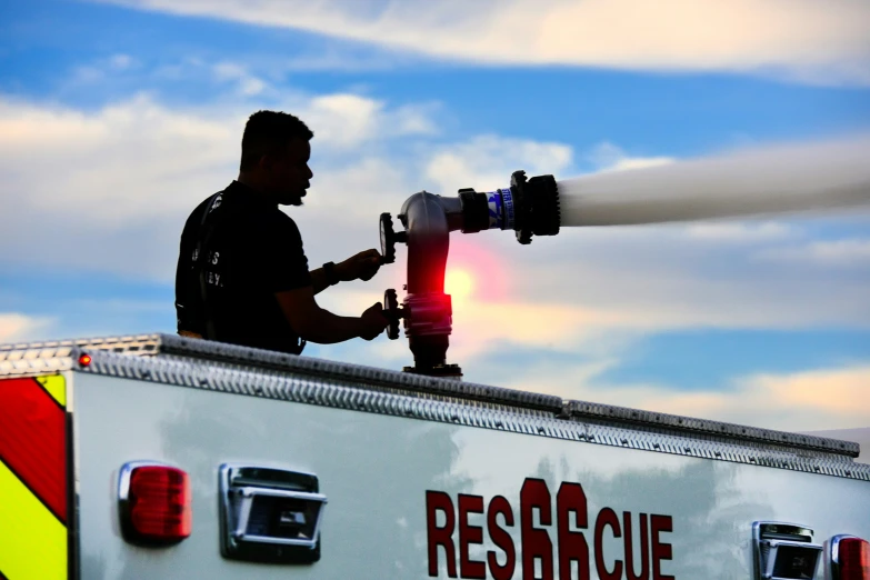 a man that is standing on top of a fire truck