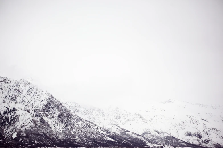 a group of skiiers in the snow near mountains