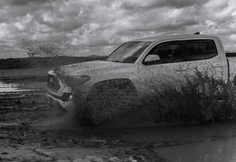 black and white po of truck in the water