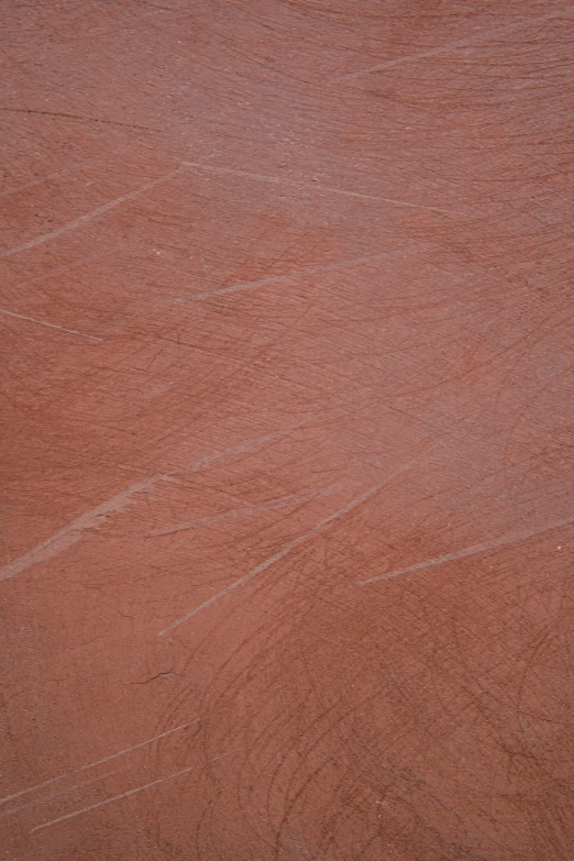 a red, clay area with the ground painted orange