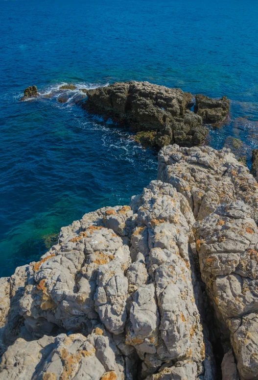 the shore is rocky and beautiful on the water