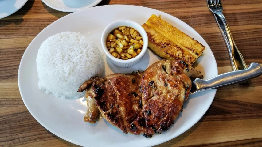 chicken, rice and a side of stew on a plate