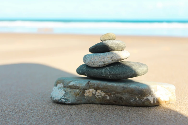 a pile of rocks sitting on top of a beach