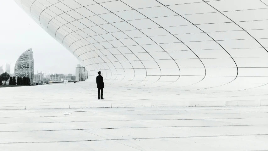 a man is standing alone in front of an umbrella