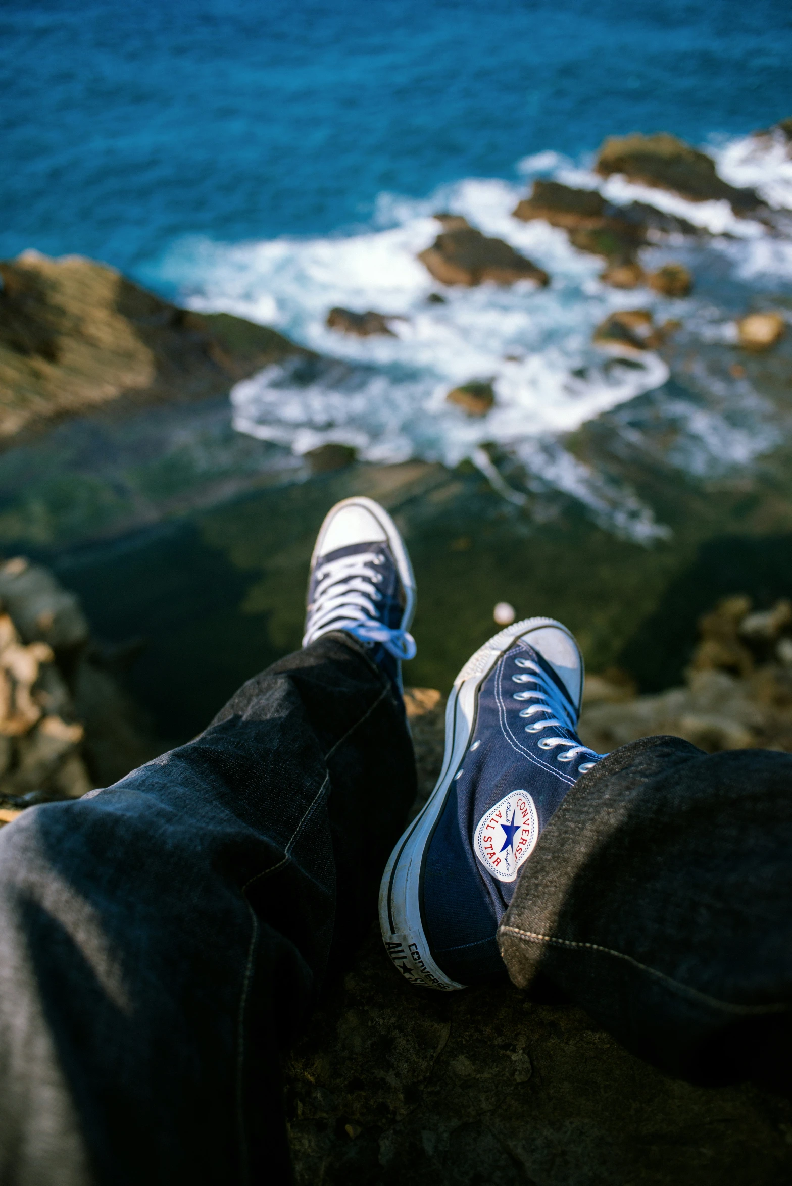 a person with their feet up looking at the water