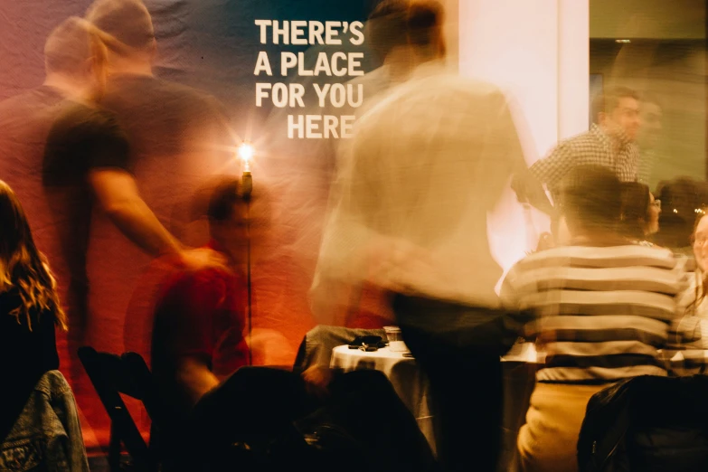 a group of people are sitting at some tables