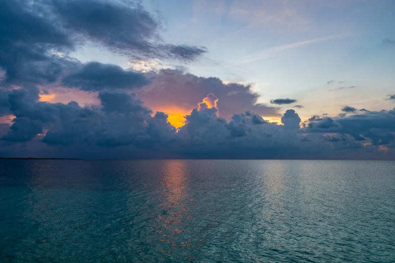 a very pretty sunset reflecting the clouds in the water