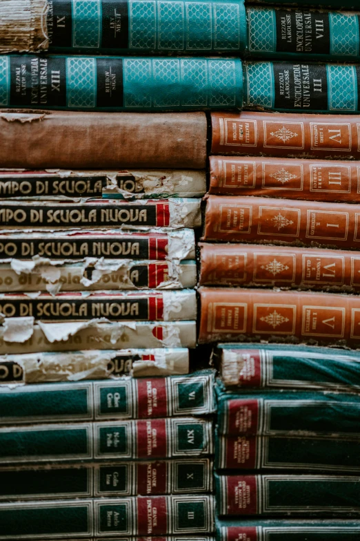 stack of books and folded papers on wooden table