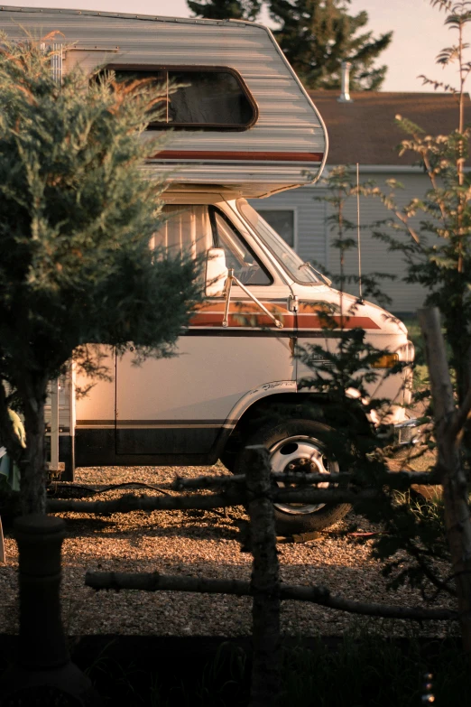 there is a parked camper with its roof raised