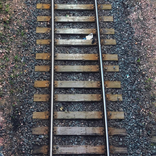 an aerial view of the railroad tracks running along one side of the street