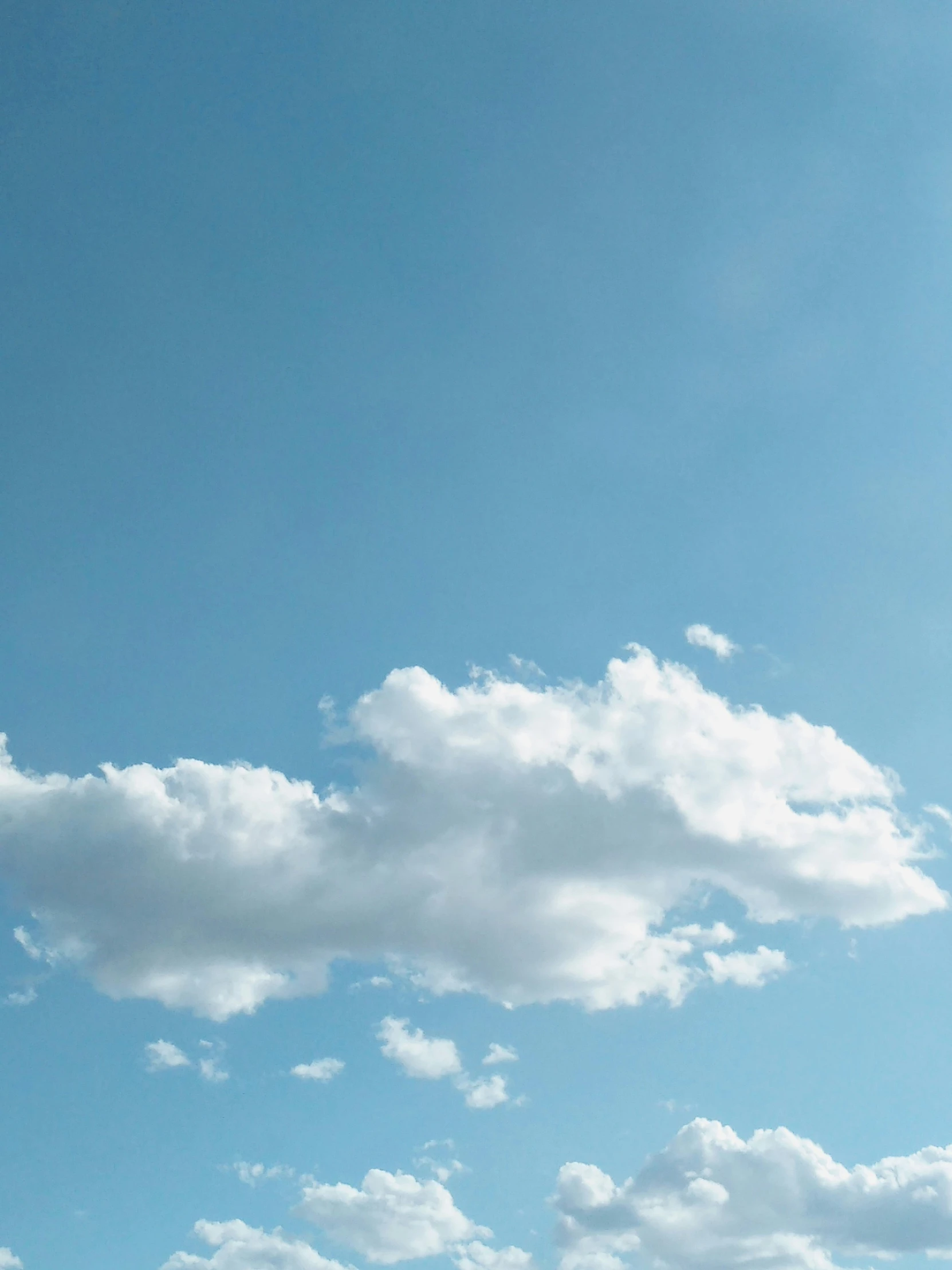 a bright blue sky filled with white clouds