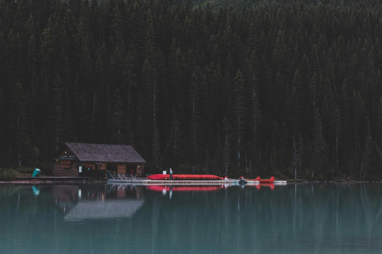 the cabin on a lake is in the evening
