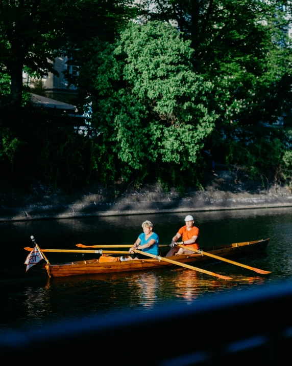 two people in small raft paddling down a river