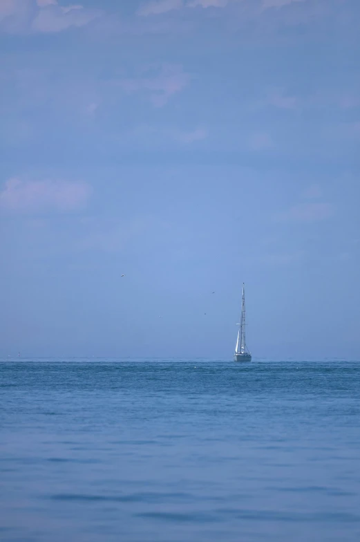 a boat in the distance is traveling through the water