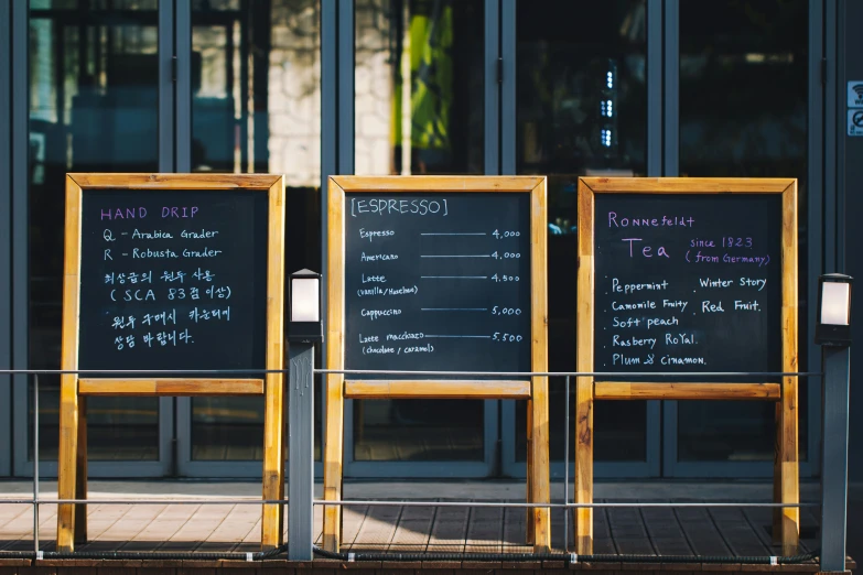 a couple of blackboards sitting outside a building