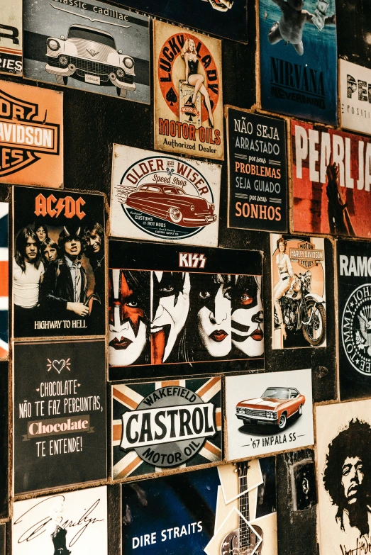 a number of beer related posters hanging on a wall