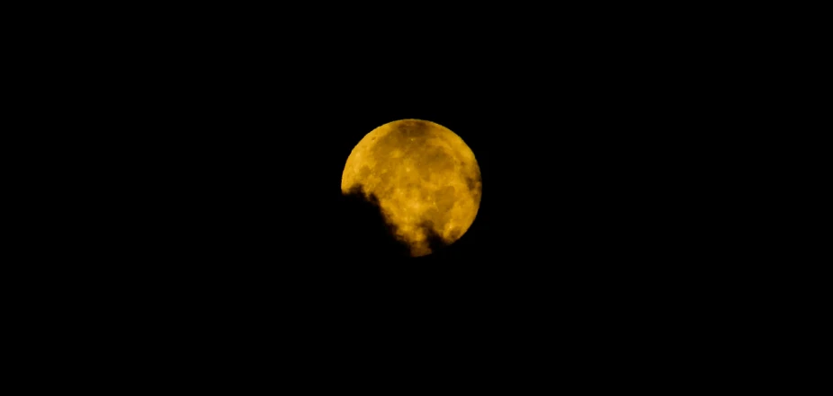 the yellow moon can be seen from the distance